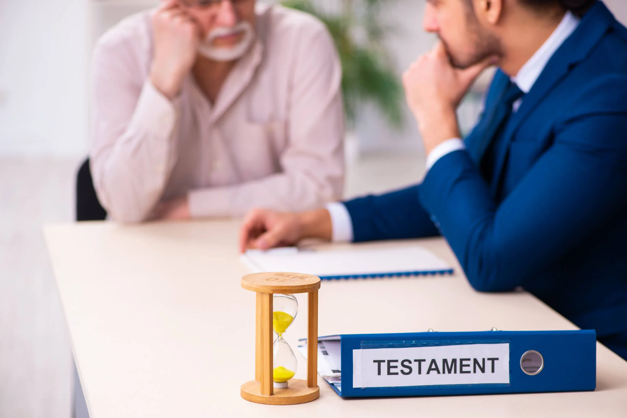 Young male lawyer visiting old man in testament concept